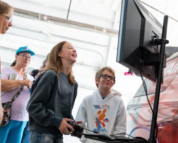Girl using simulator as group watches