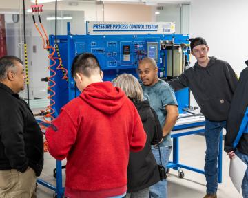 People exploring open house looking at the pressure process control system