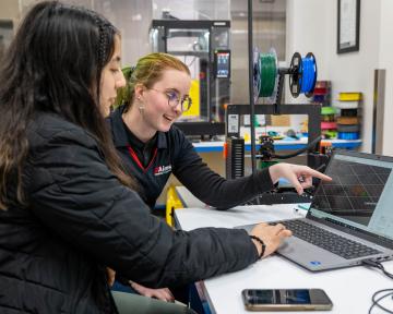 students on laptop in industrial tech lab