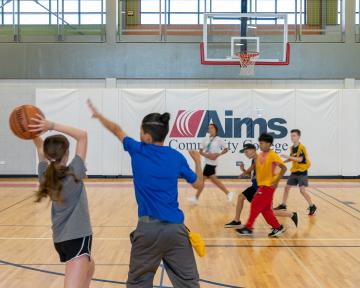 Students playing basketball at the PERC