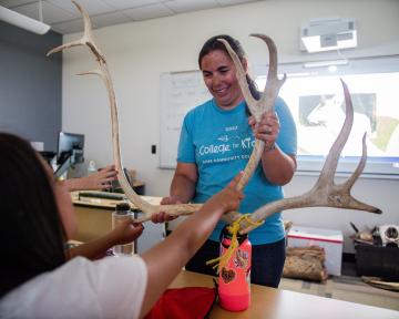 Teaching handing a student antlers