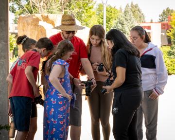 Students in a crowd looking a camera in photography class