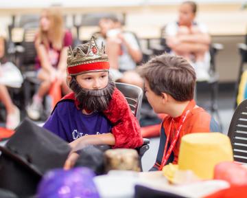 Students in acting class dress as a king and Spiderman