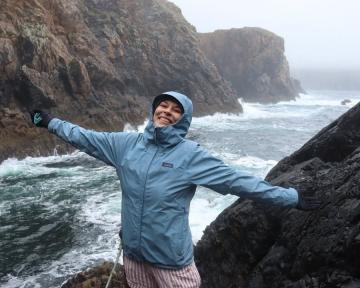 Aims student with arms streched near water
