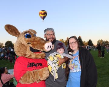 Family with Arty with hot air balloons in background