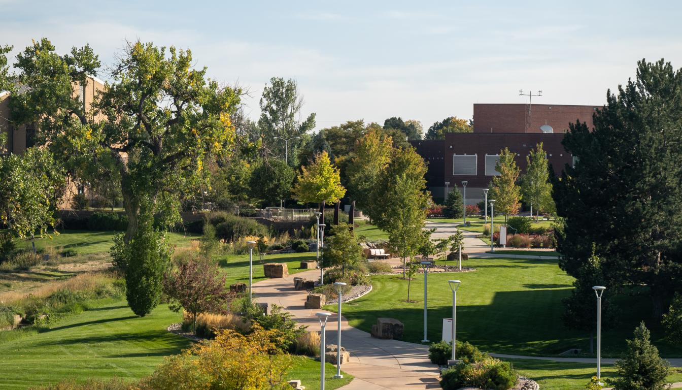 The winding brick walking path leading to buildings on the Aims Greeley campus