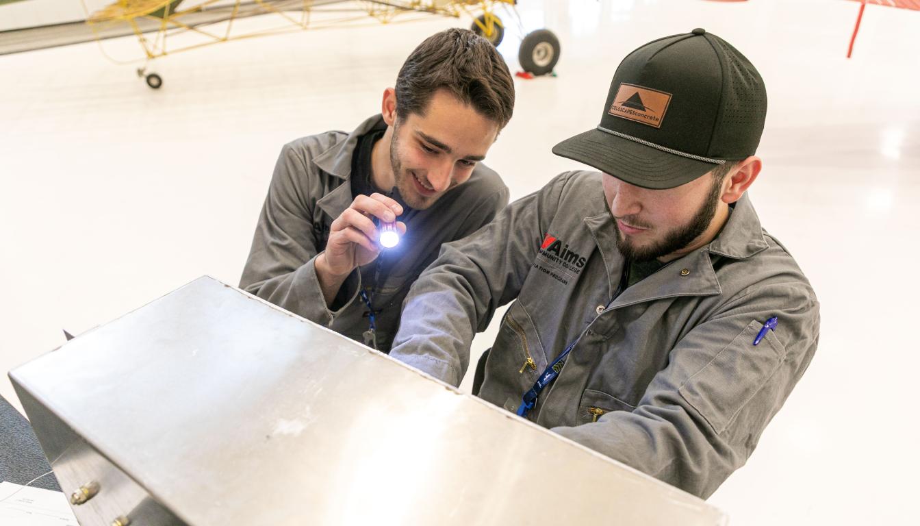 Aircraft Maintenance Students inspect and airplane