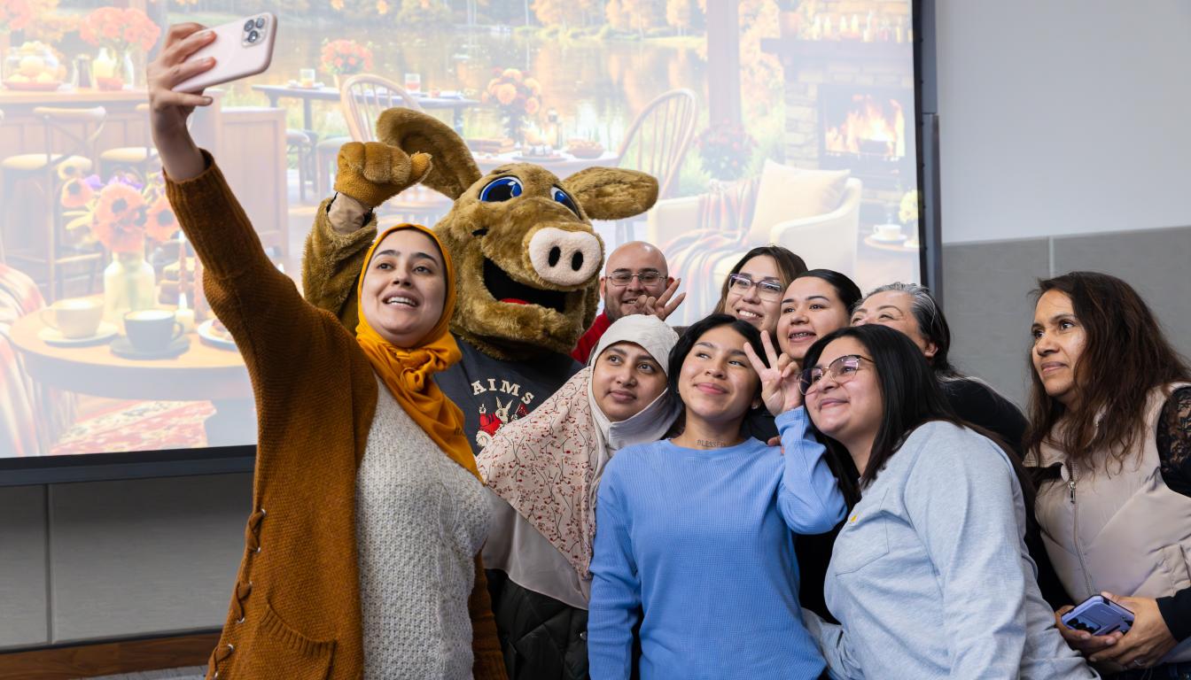 Students in Adult Education and English Language Learners programs take a group selfie during a year-end celebration
