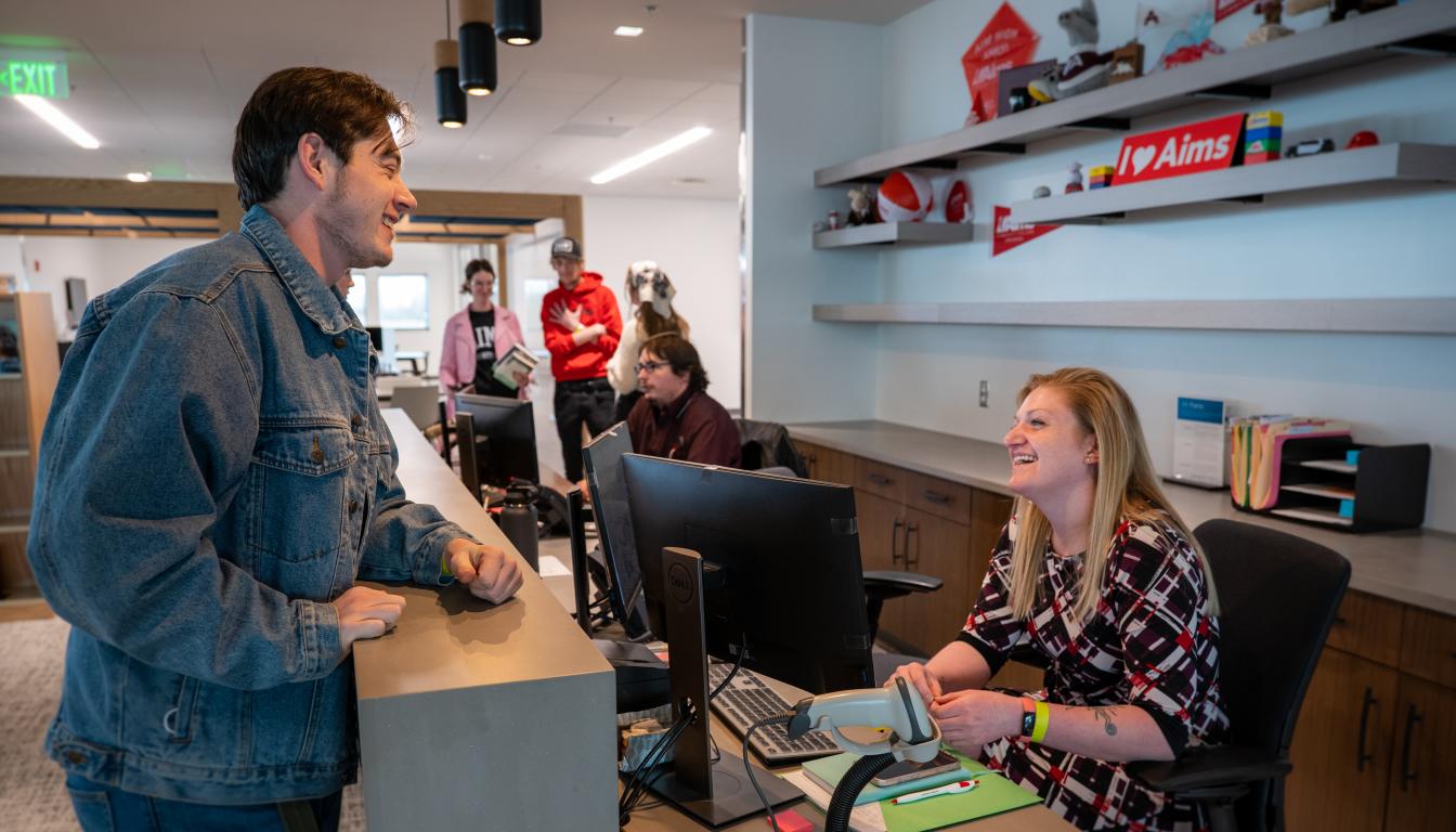 Zack at the front desk at the Learning Commons