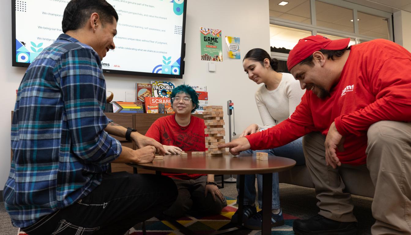 student playing Jenga at the MOSAIC at Aims
