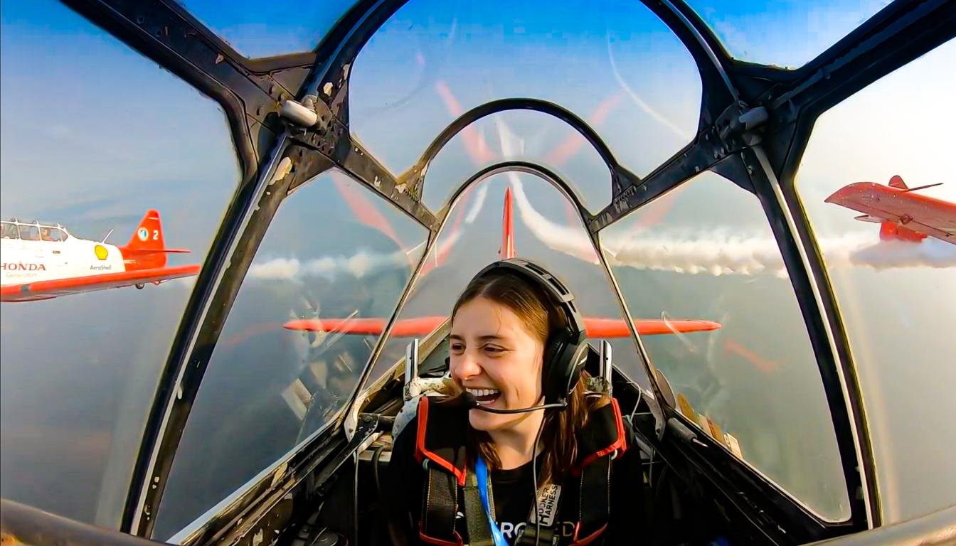 Aims Community College Certified Flight Instructor Sara Bauermeister flies with pilot Mark Henley who is part of the Aeroshell Aerobatic Team during the 2021 EAA AirVenture Oshkosh airshow.