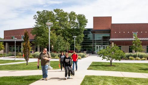 People walking on Aims Campus; Student Commons in Background