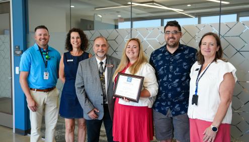 Kira Davis Weber with others accepting the award
