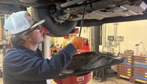 Andrew Schmunk fixing a car