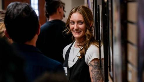 people talking and viewing art at Aims Art Show