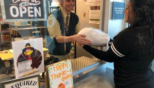 student handed food at Arty's Pantry