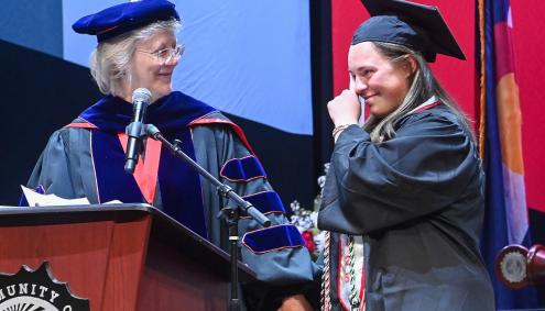 Dr. B awards Sarah Garcia with an award at Commencement