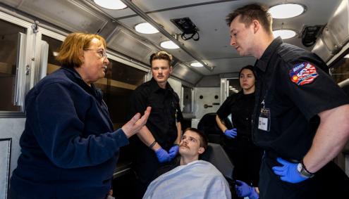 Kristie Skala with students in ambulance simulation