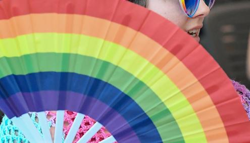 Woman in Hat with rainbow fan