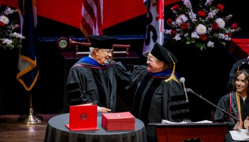 Lyle Achziger and Marilyn Schock presenting the Distinguished Fellow Award