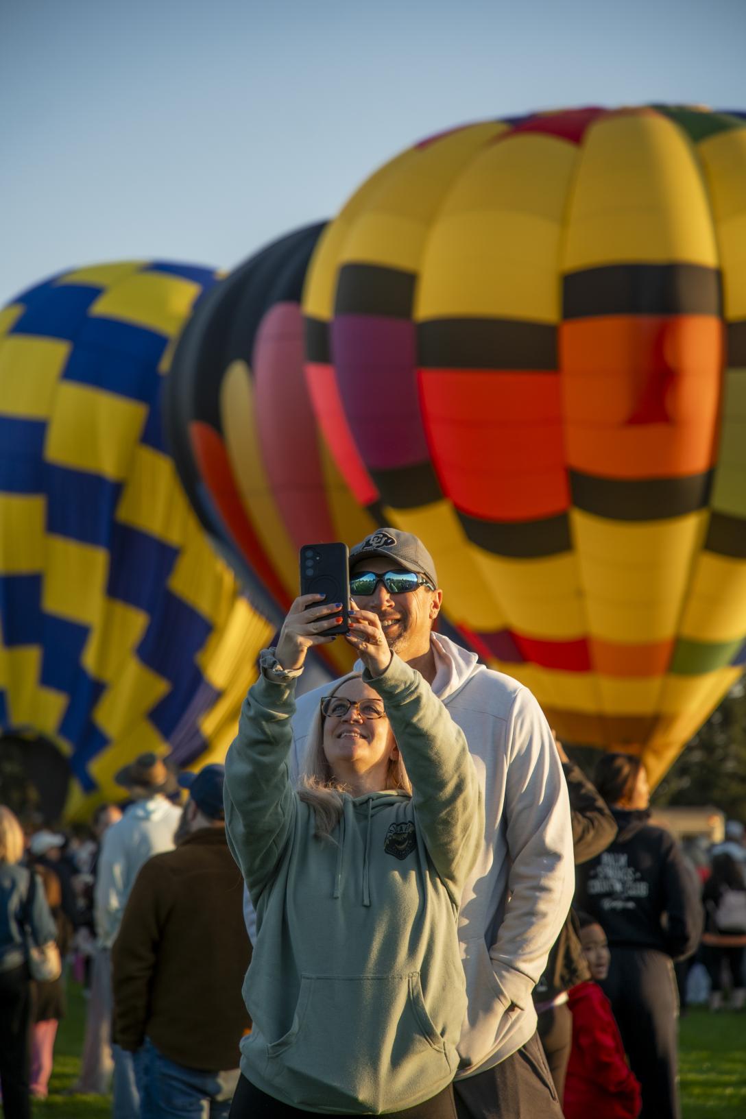 couple taking selfie with hot air balloons
