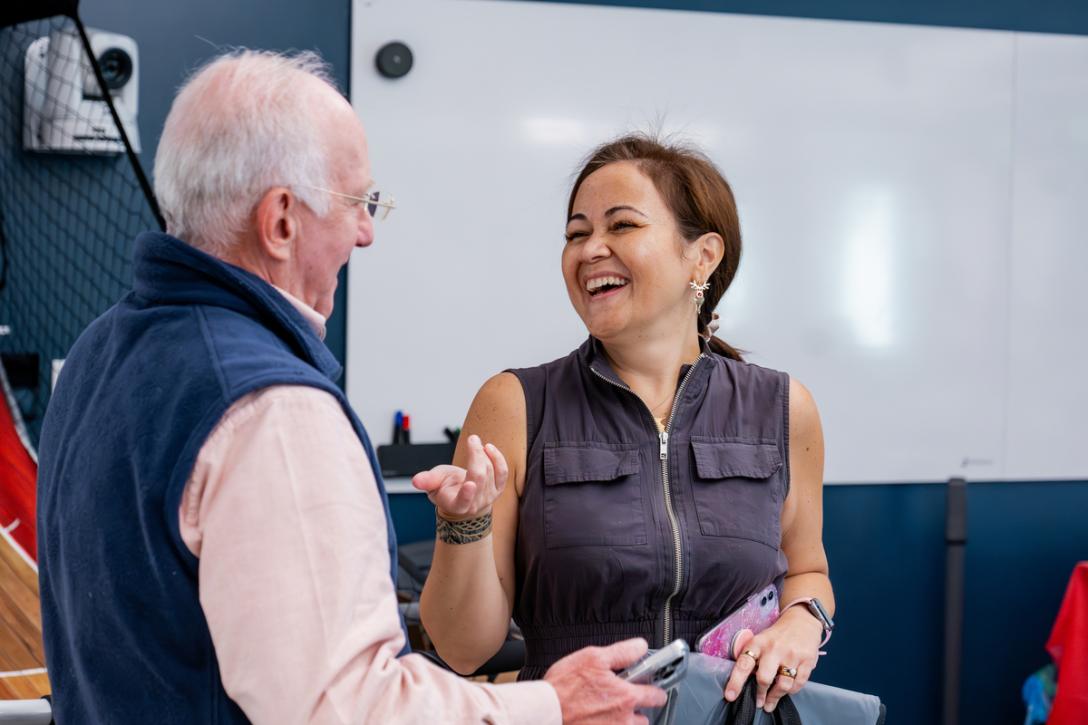 Adult Education student and instructor laughing together