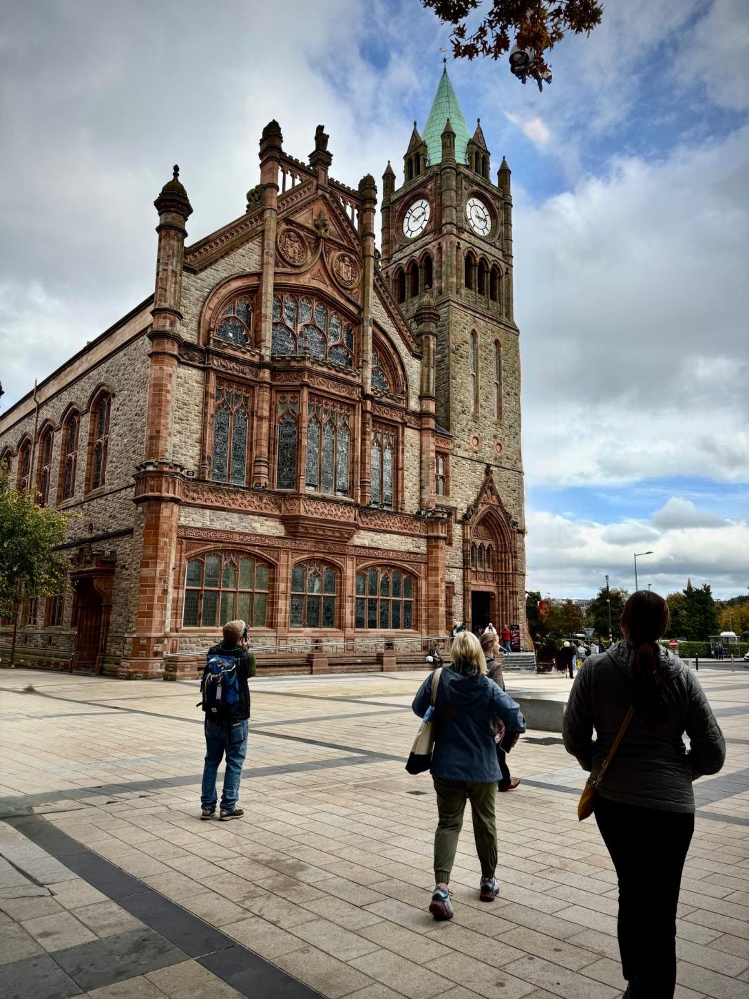 people walking towards Guildhall in Derry in Northern Ireland.