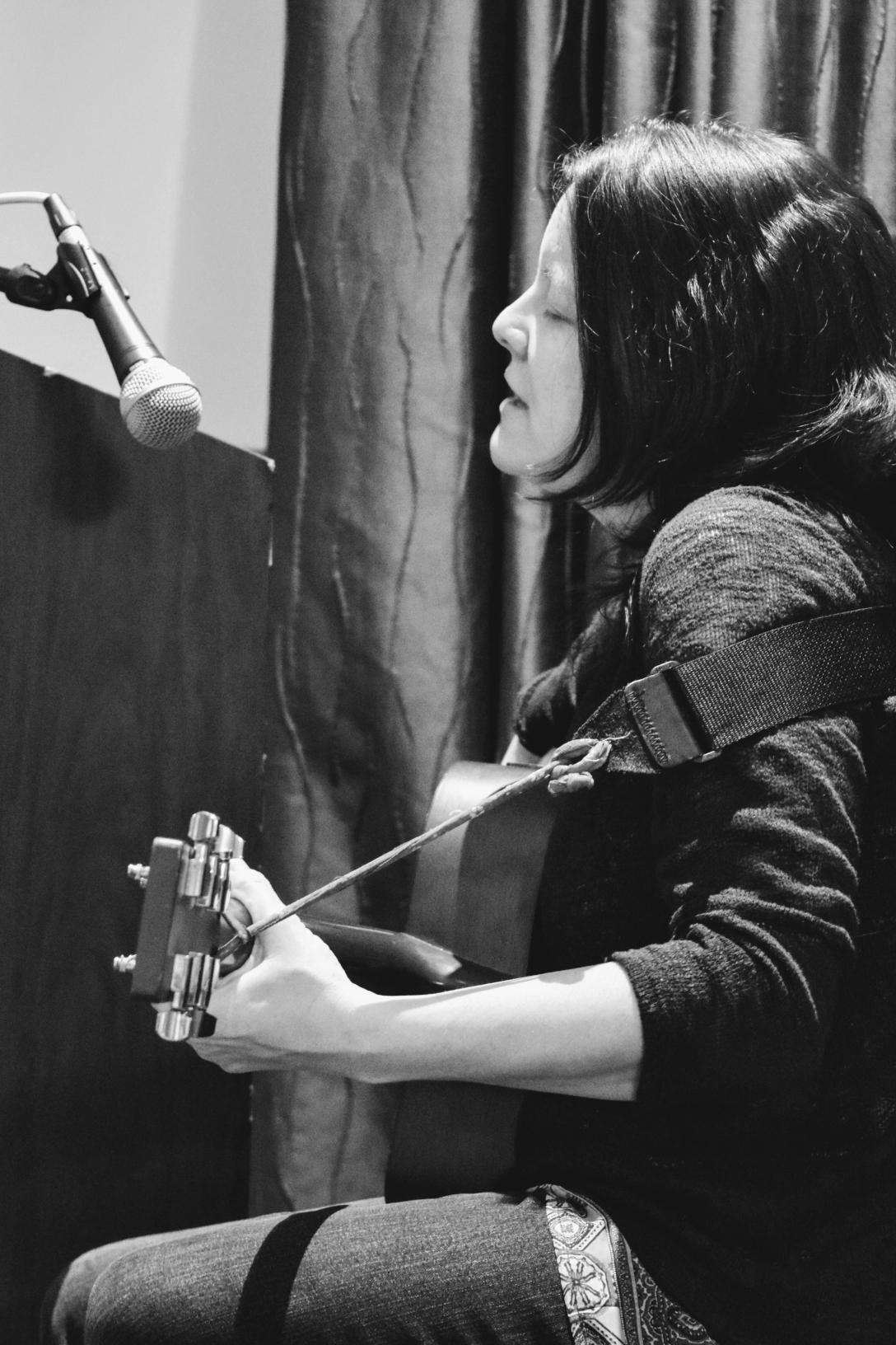 Woman with guitar singing