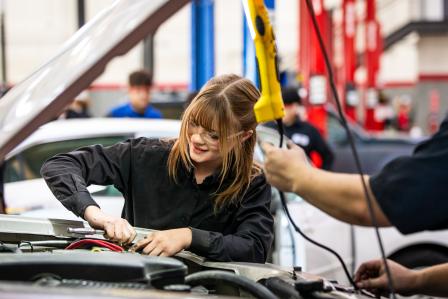 Aims student repairing vehicle