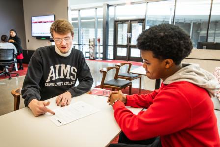 A Financial Aid Advisor talks with a student about their options