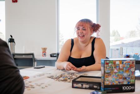 Kodee Davis laughing and putting together a puzzle