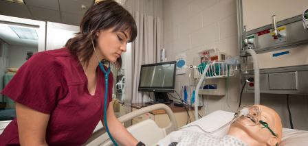 Nursing Student practicing on mannequin 