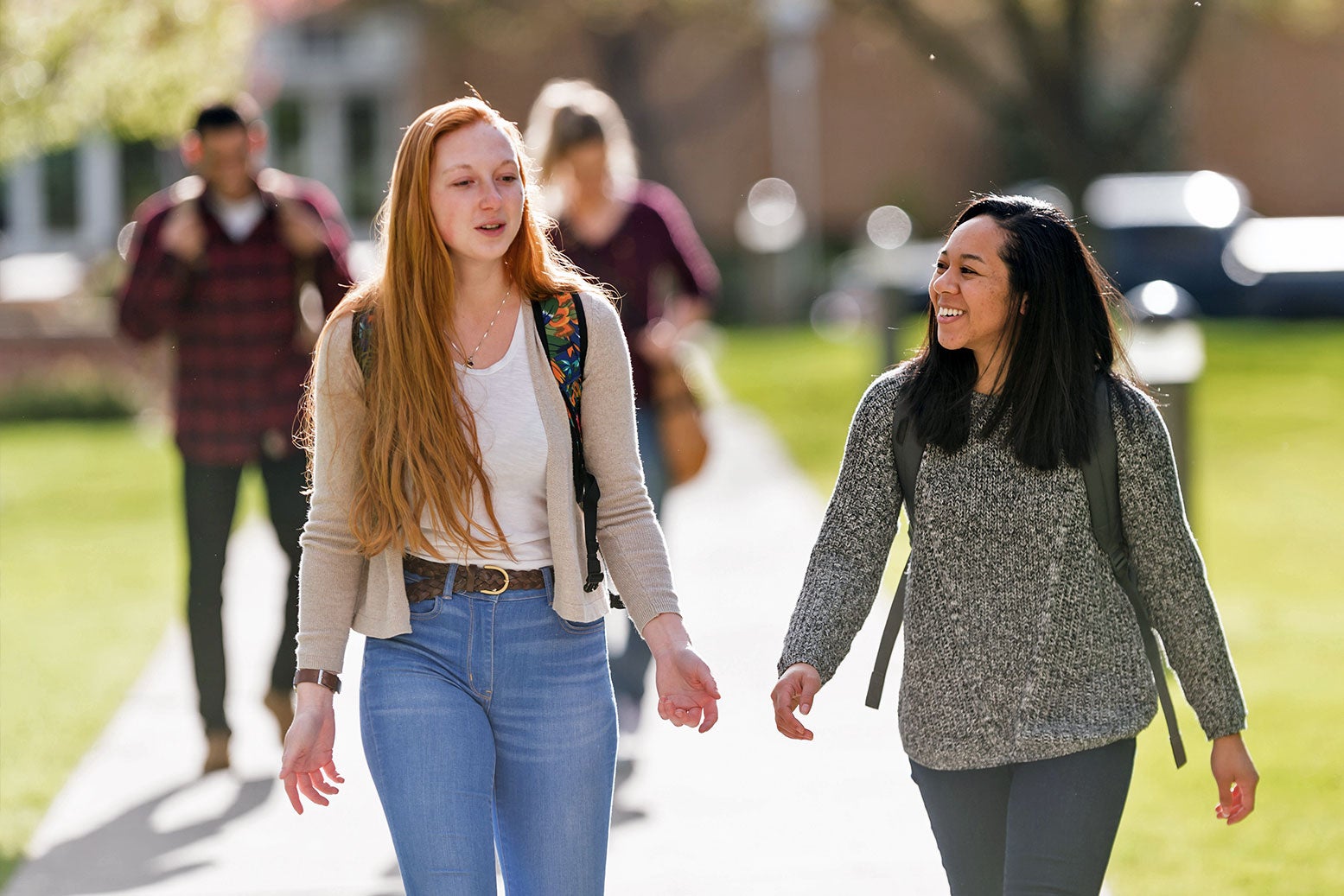 Two transfer students walking on campus
